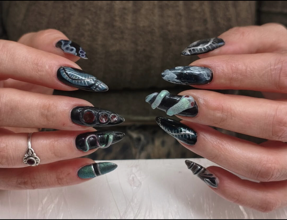 Dark stiletto nail art with sculpted 3D elements