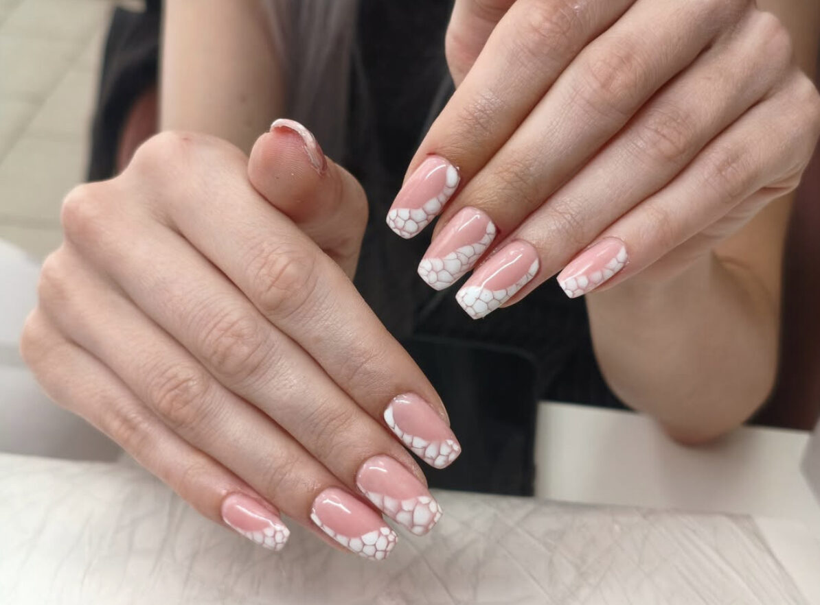 Pink and white French manicure with painted stone-pattern tips on long square nails