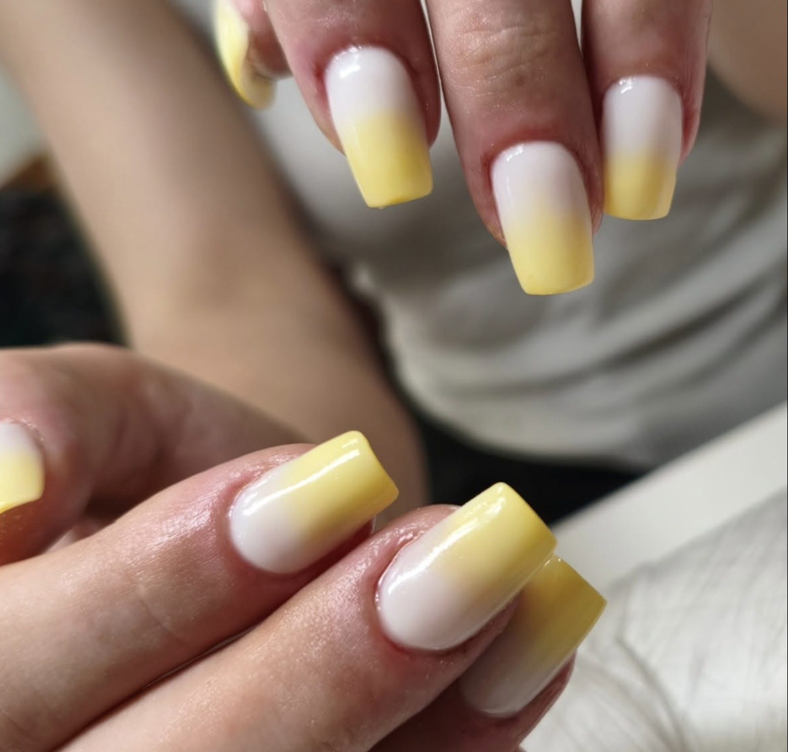 Glossy pastel yellow ombré French tip square gel manicure